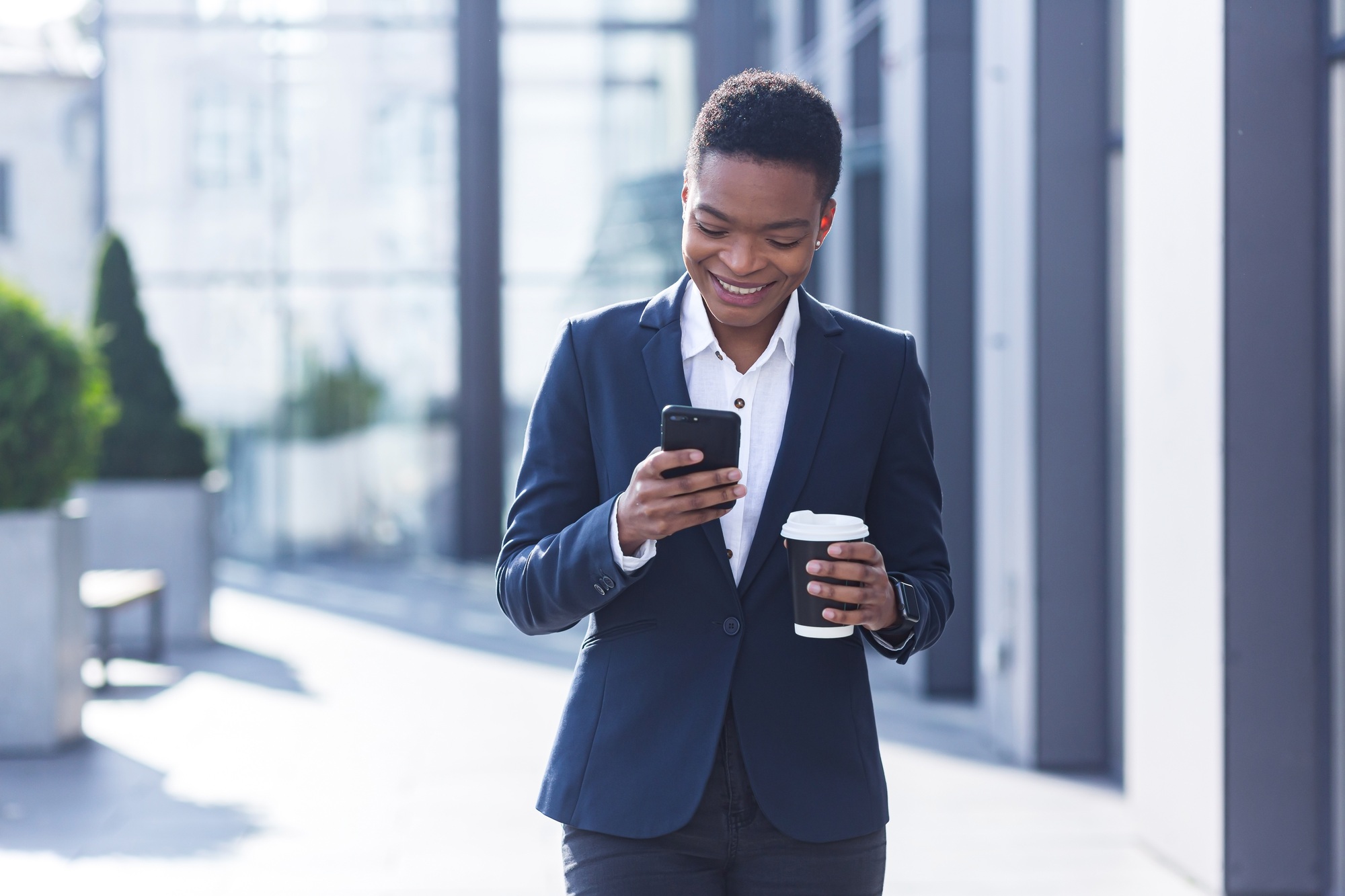 Business woman enjoys cellphone fun and smiling, African American boss businesswoman